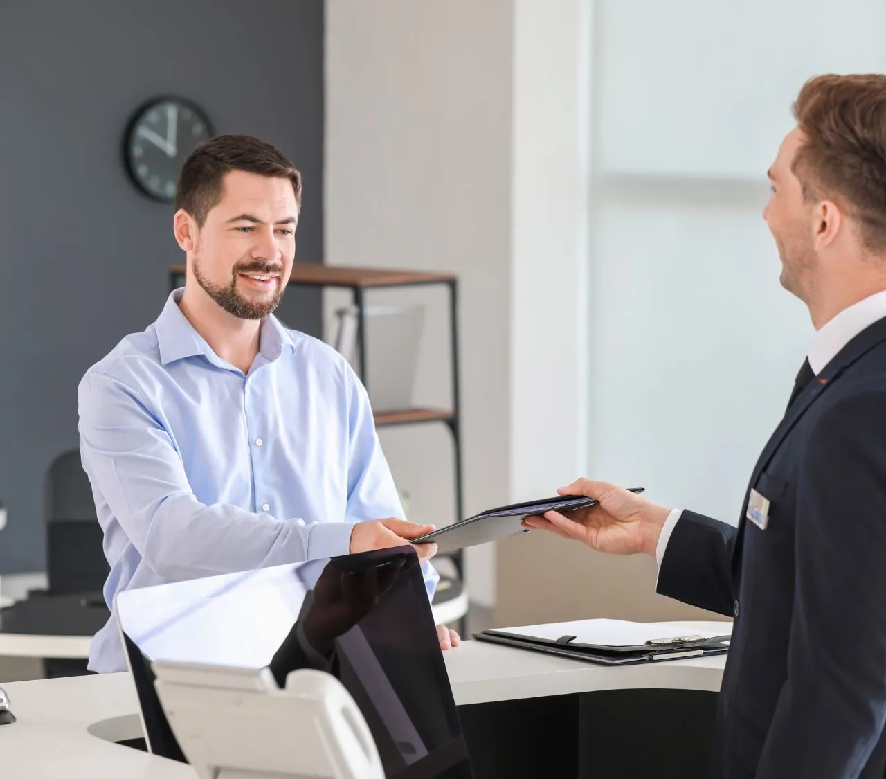 Visitor welcomed at a company reception desk