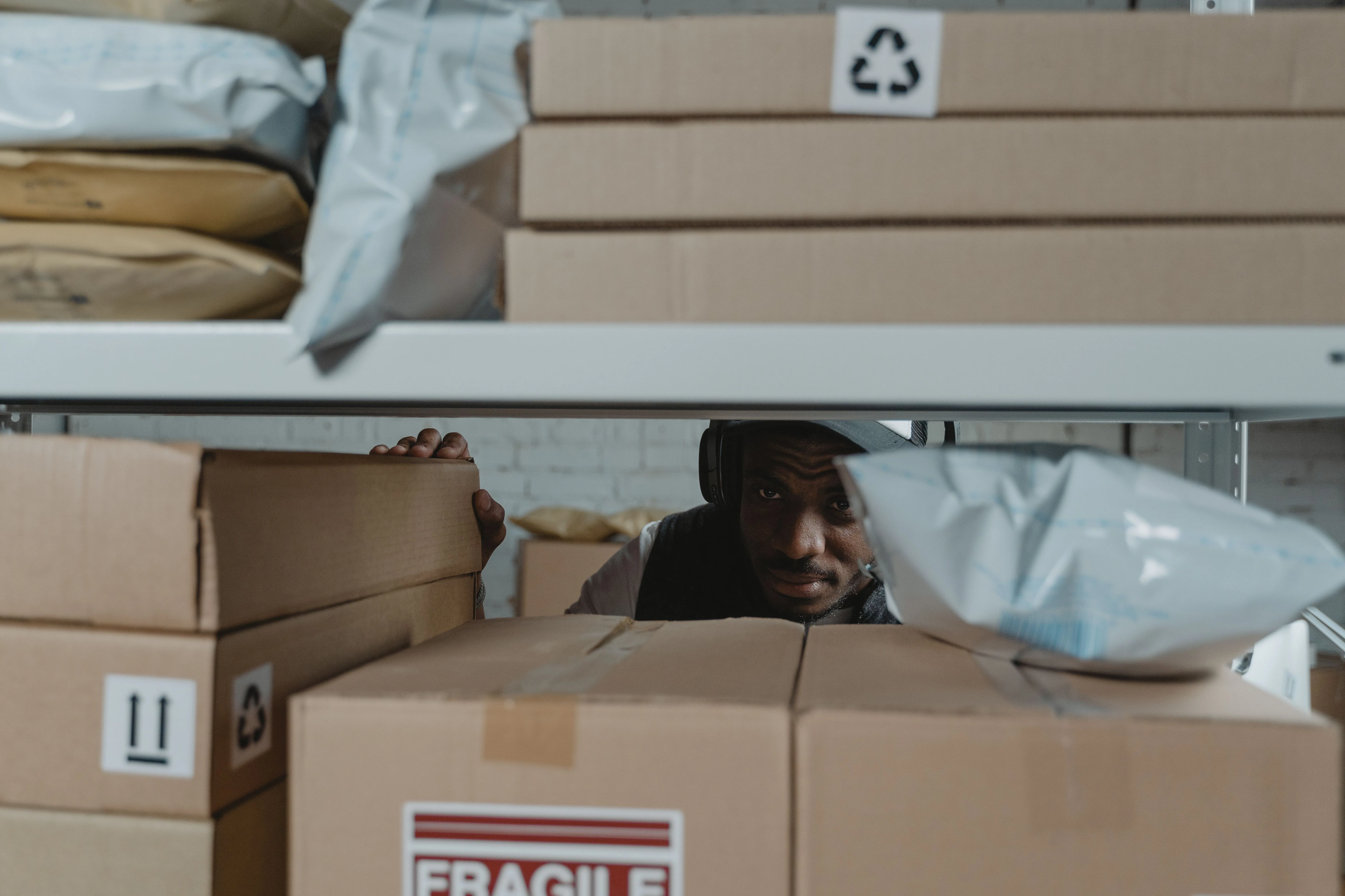 Parcel and mail storage area in a workplace, with boxes and envelopes stored on shelves