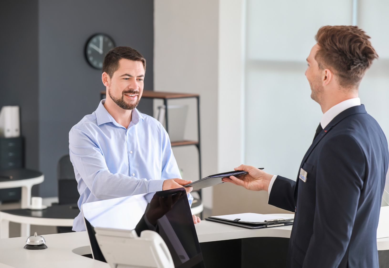 Visitor being welcomed at a company reception by an employee