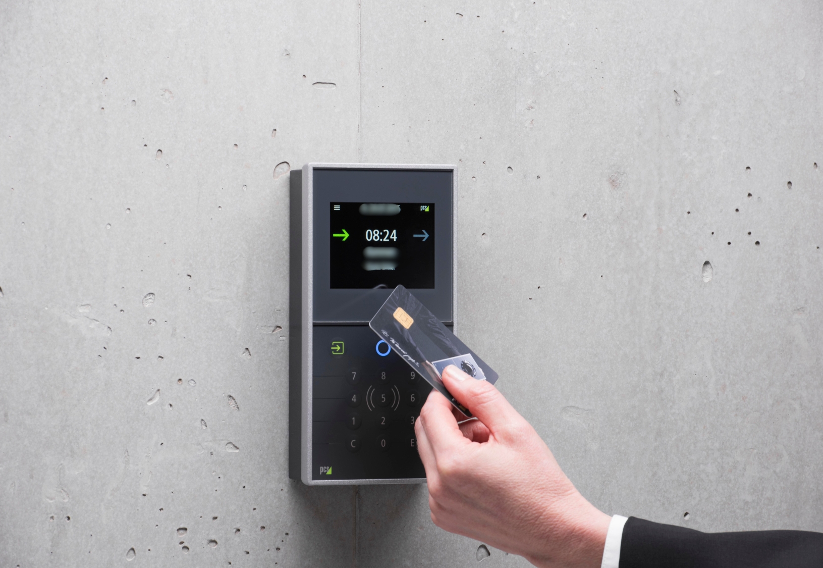 Person presenting a badge to an electronic reader to enter a secure area of a business building