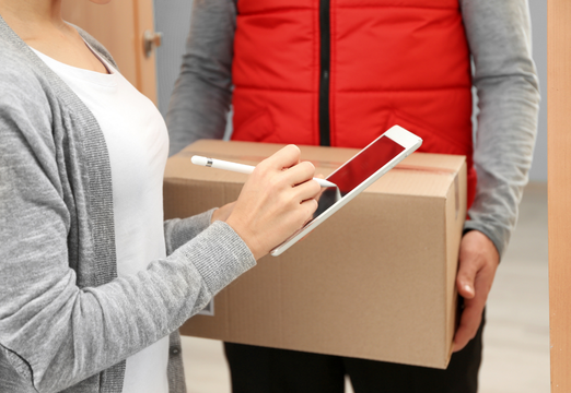 Parcel received at the workplace with an electronic signature on a tablet to log and track the delivery.